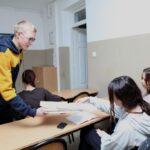 Uczniowie rozdają kremówki uczniom