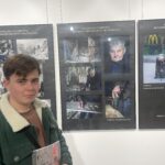 Uczeń z pracami na wystawie