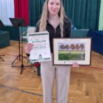 Uczennica ze zdjęciem i nagrodami